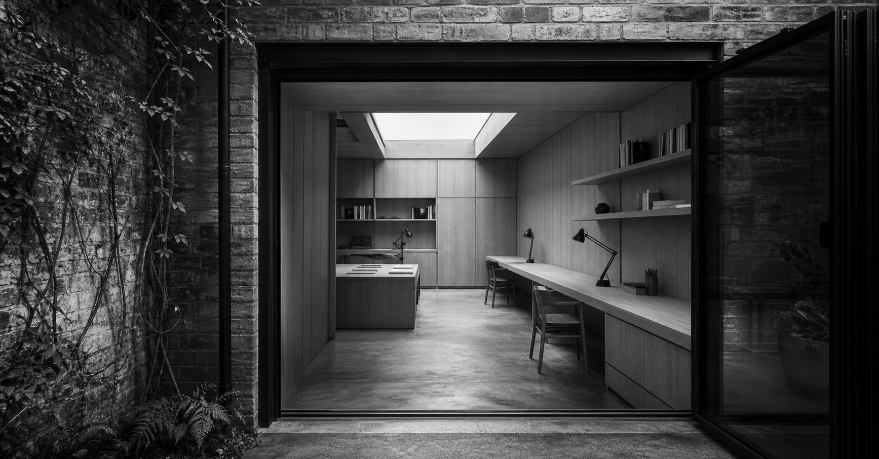 Compact brick mews studio conversion with timber-lined workspace